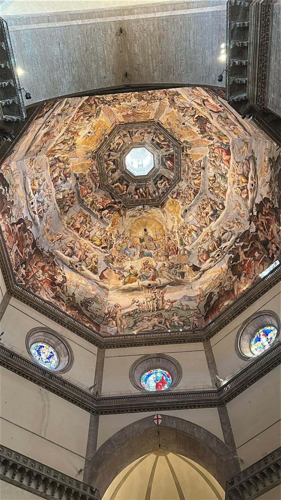 Vasari's Last Judgement covering the inside of Brunelleschi's dome above the cathedral's stained glass
