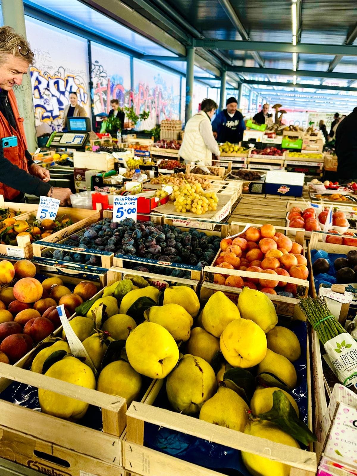 Crates of quince, plums and peaches on a Florence market stall