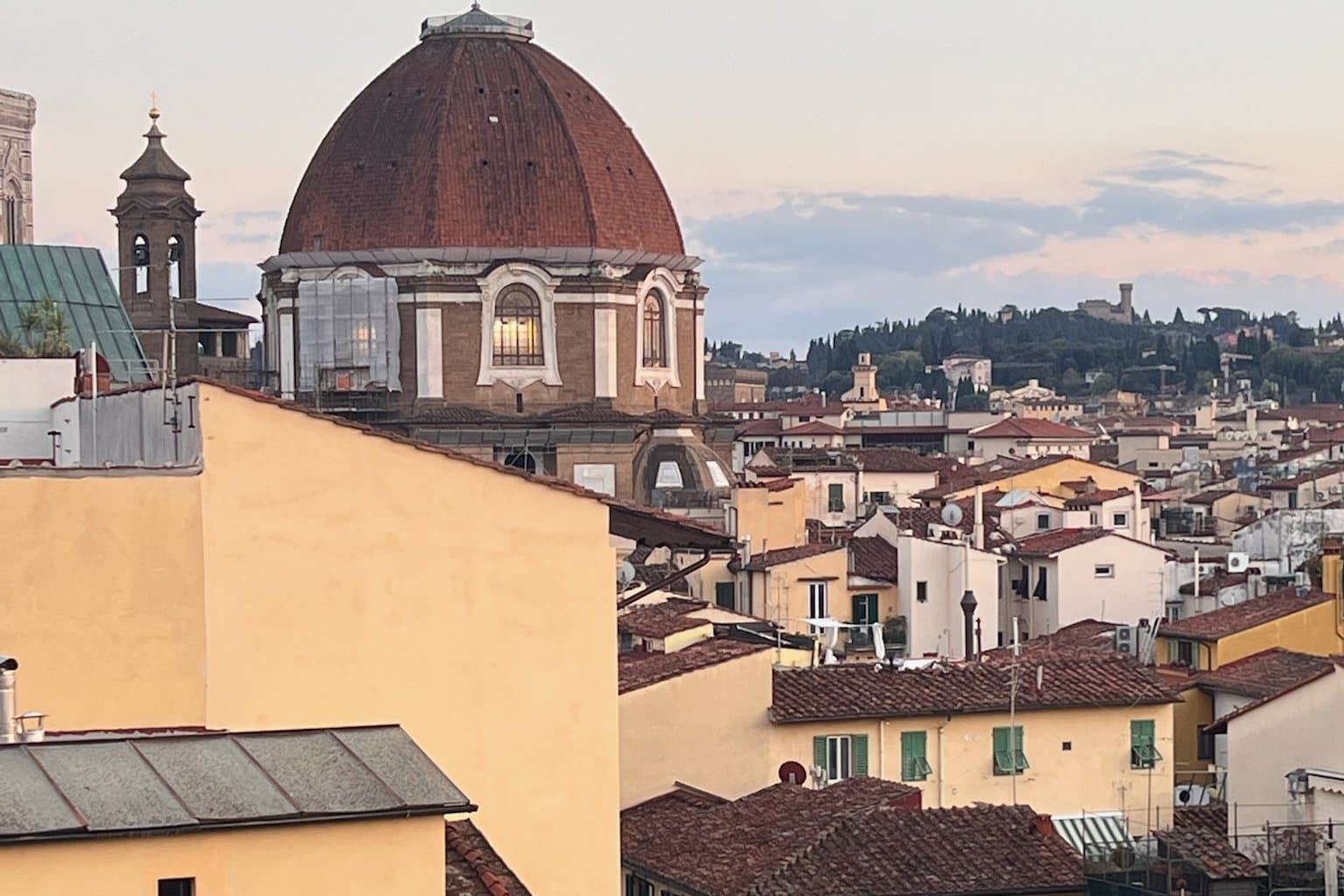 Florence rooftops and a domed church in the last of the evening light