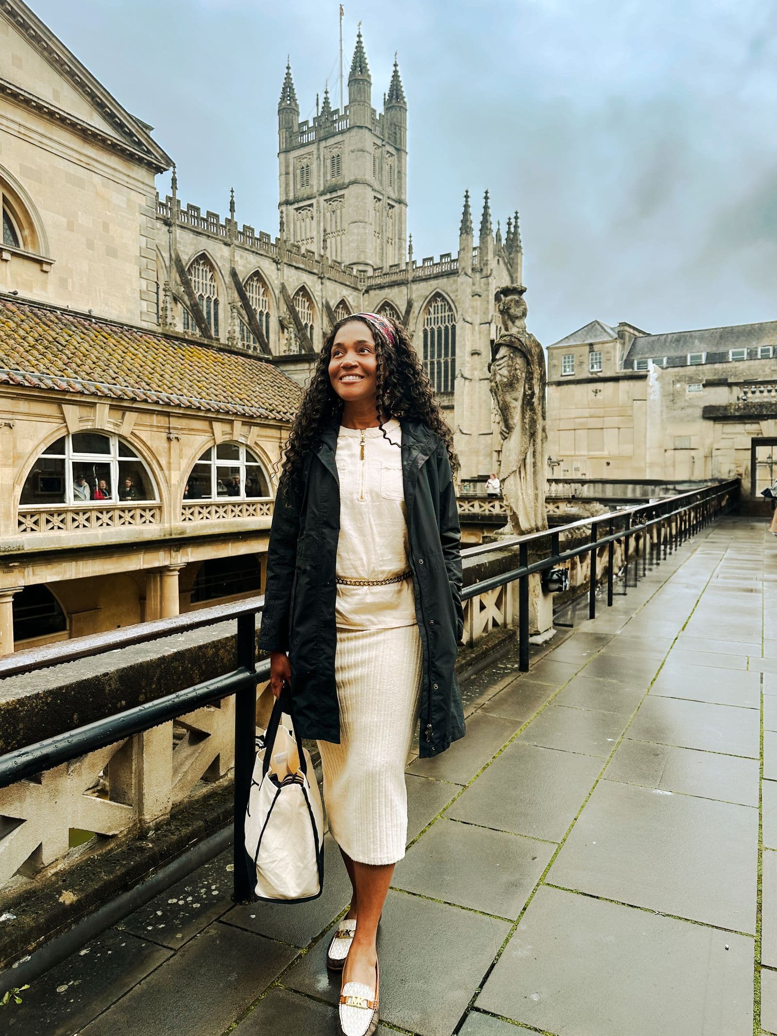 Kerry-Ann Stephens walking past Bath Abbey on a wet afternoon