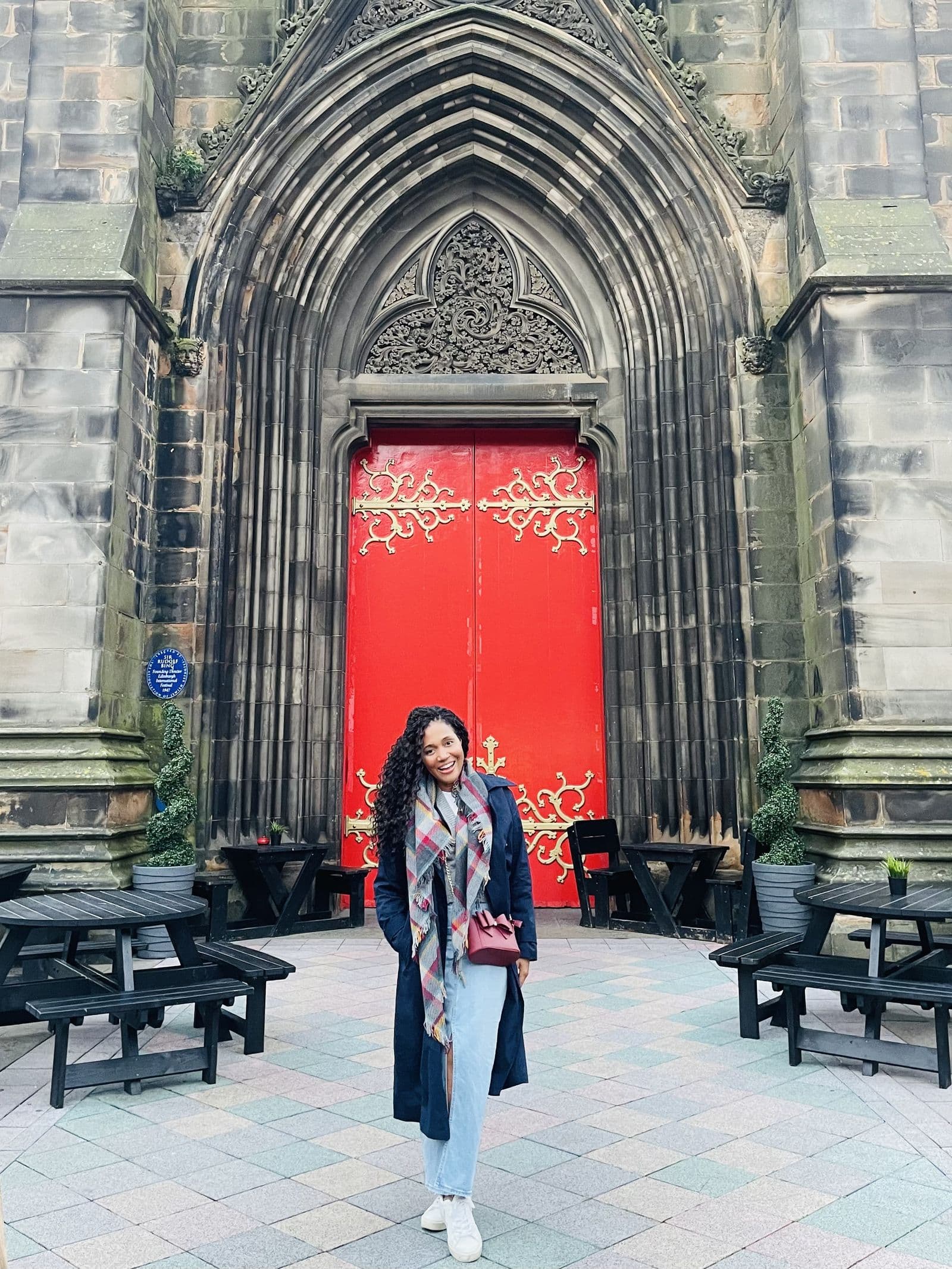 Kerry-Ann Stephens in front of the red doors of St Giles' Cathedral in Edinburgh