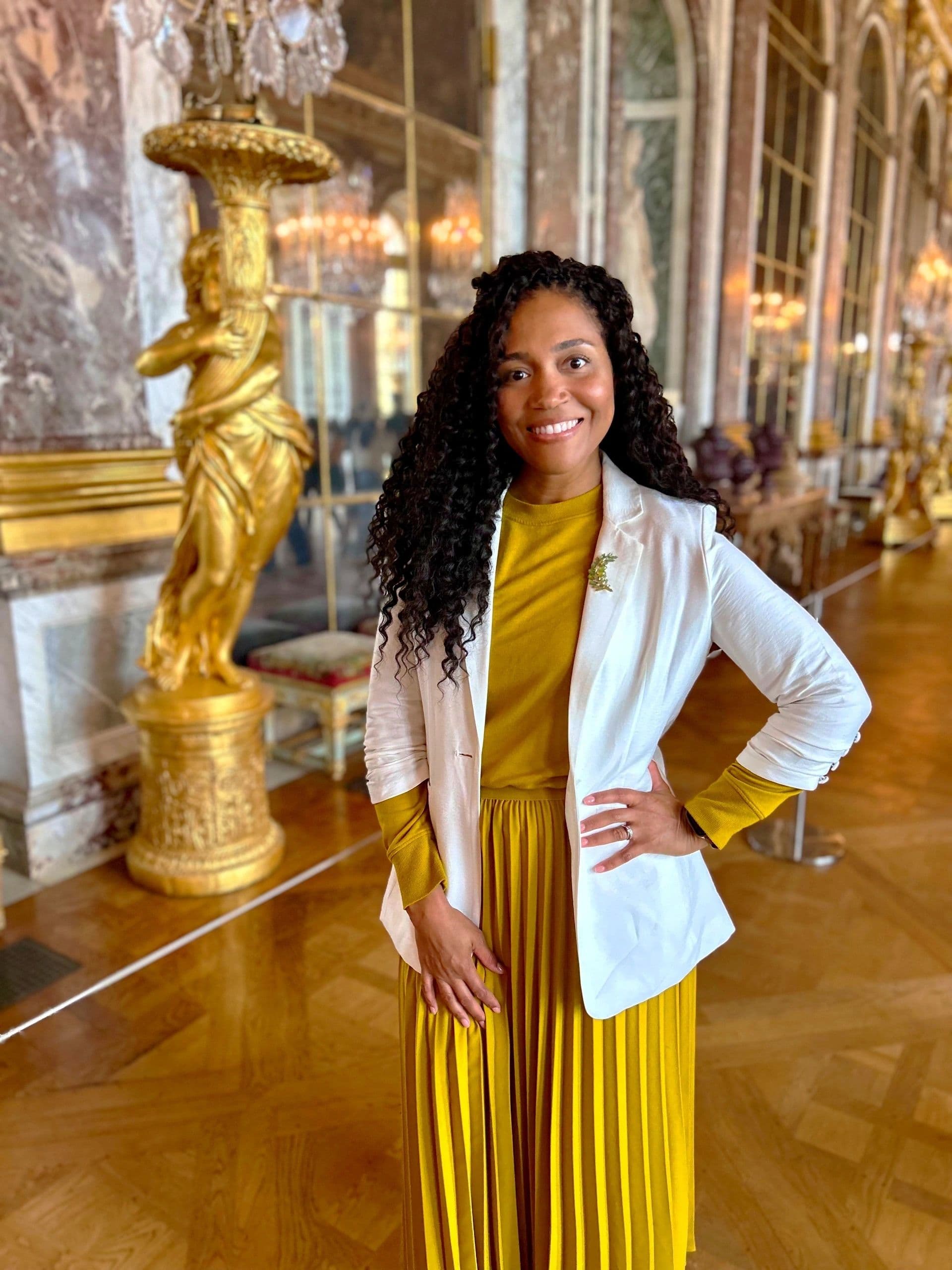 Kerry-Ann Stephens standing in the Hall of Mirrors at the Château de Versailles