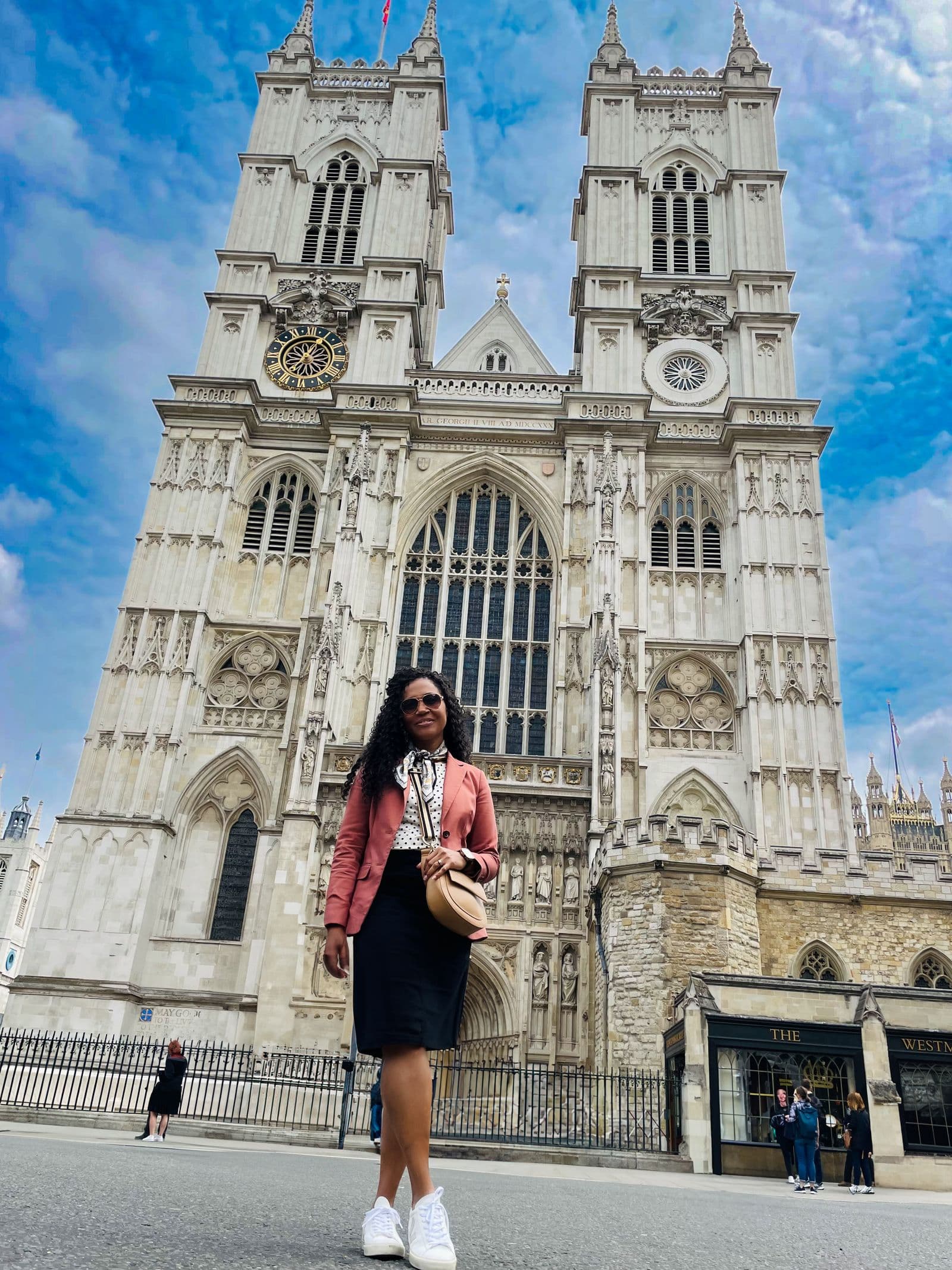 Kerry-Ann Stephens standing in front of the west front of Westminster Abbey