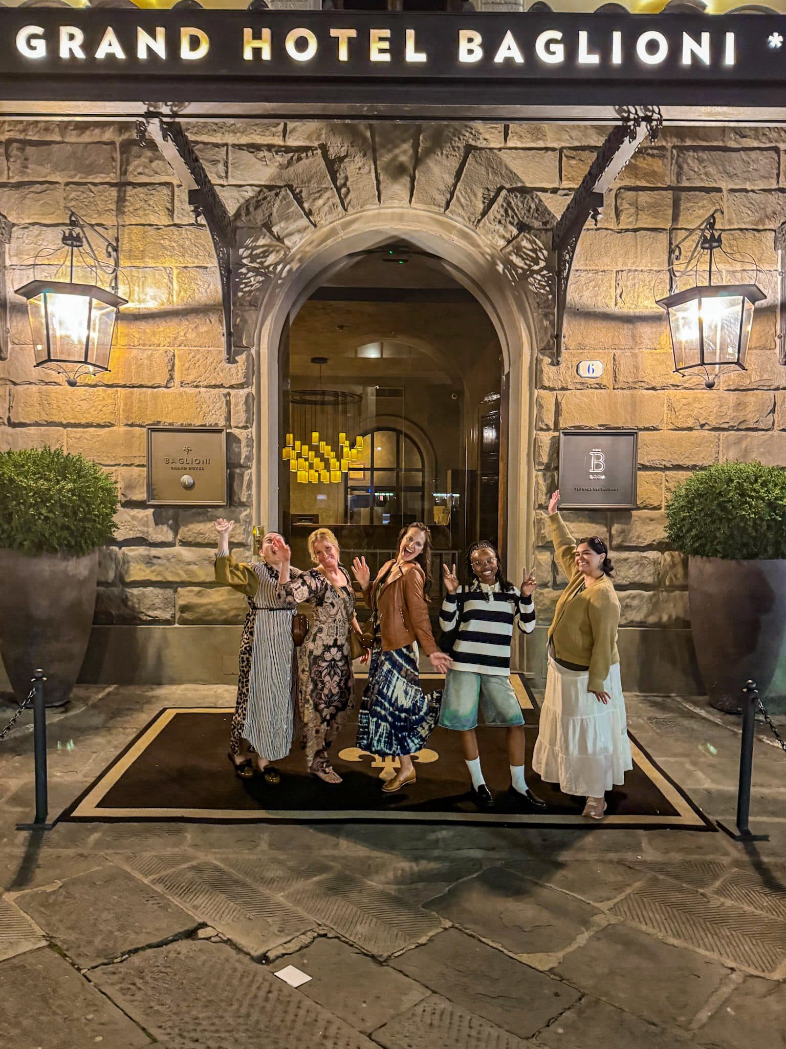 A group of women together at the entrance of their hotel in Florence