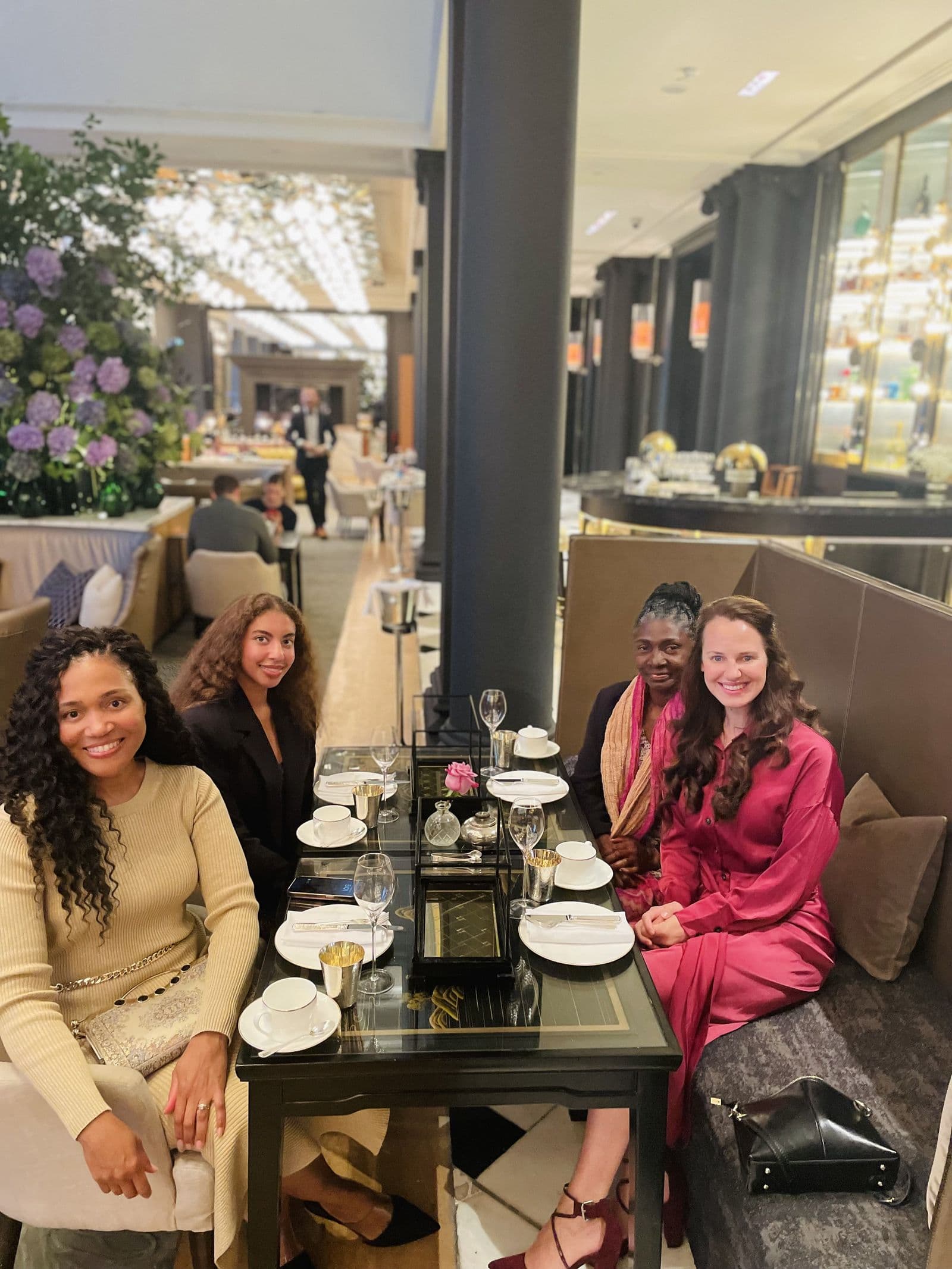 Four women together over afternoon tea in a bright London dining room