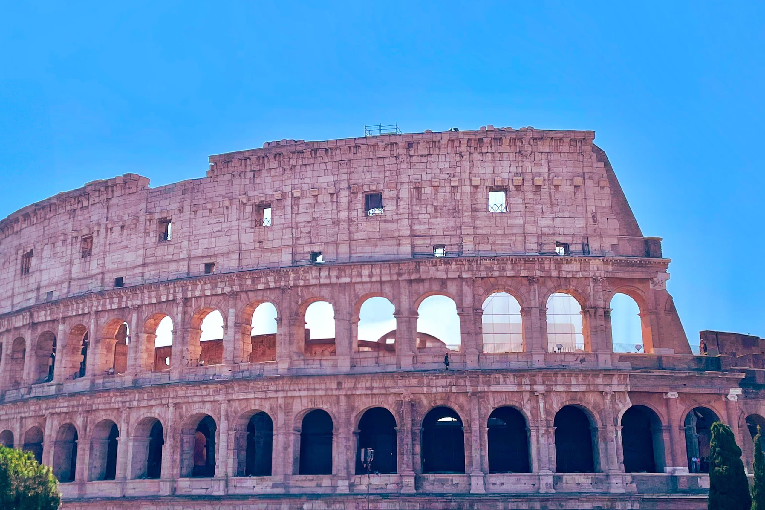 The Colosseum in Rome against a clear blue sky