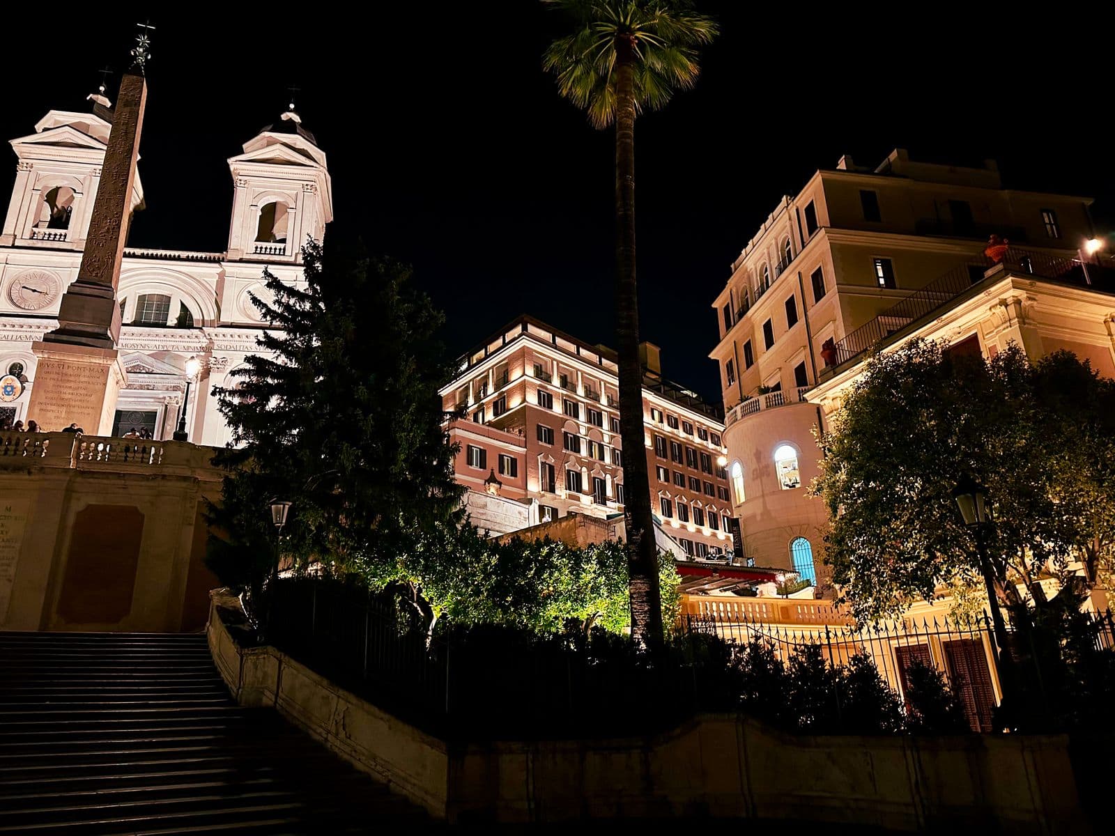 The Spanish Steps at night, lit warm against the dark sky